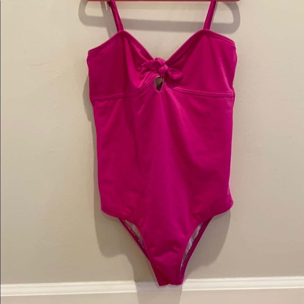 A girls hot pink billabong one piece bathing suit